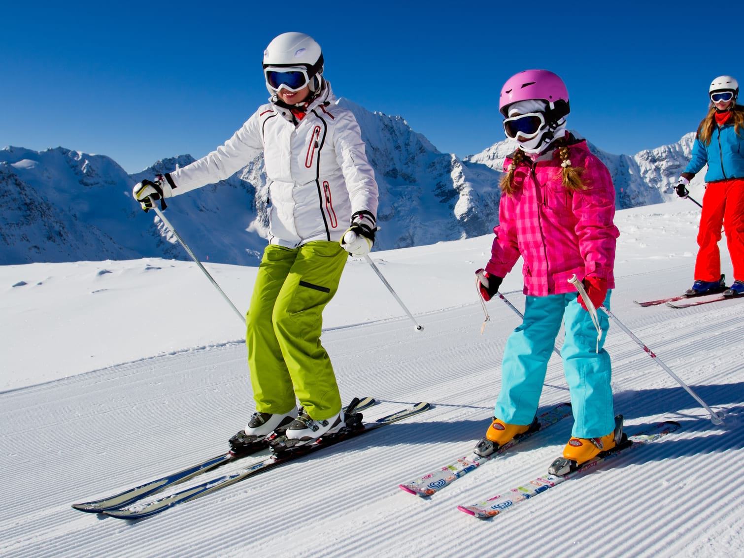 Family skiing on groomed piste