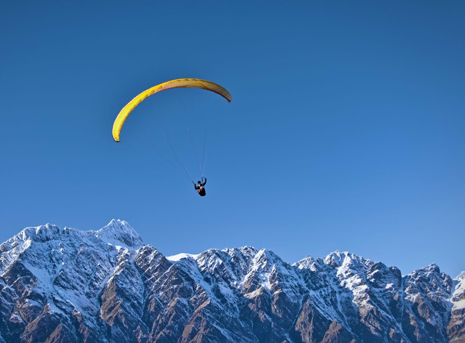 Paragliding over snowy peaks
