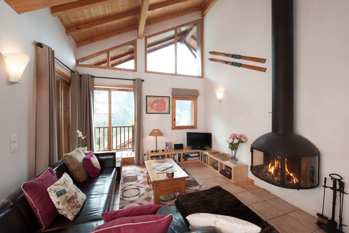 The living area has plenty of seating and has an abundance of natural light, thanks to the floor-to-ceiling windows