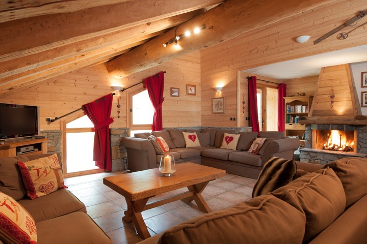 The spacious living room in Chalet La Vanoise, with beautiful log fire & plenty of comfortable seating