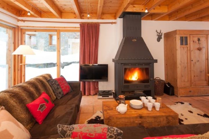 Chalet C'est La Vie has an inviting interior, with its exposed wooden beams, warm furnishings and log fire